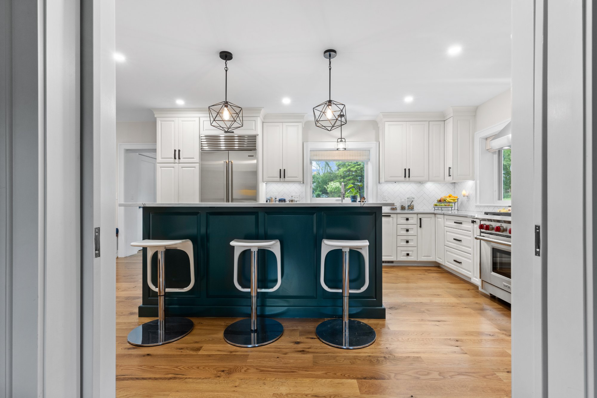 White kitchen with dark green island — English Cottage, Greenspring Valley